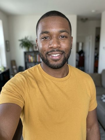 Input portrait of a person wearing a yellow shirt.
