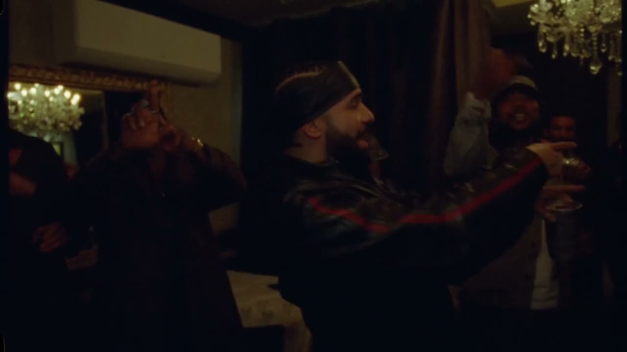 The Burning Bridges reference performer gestures toward the camera while holding a metal cup.